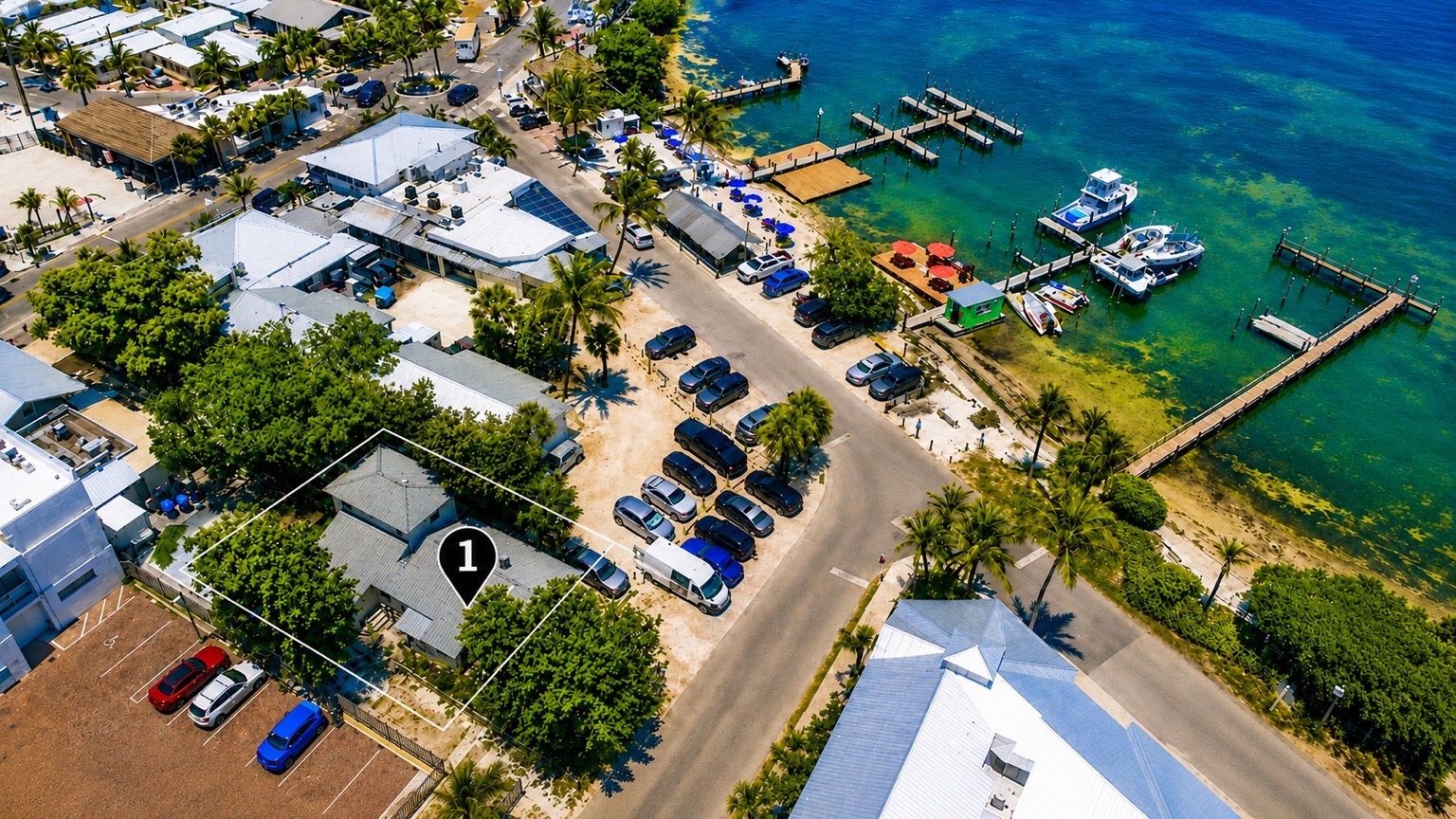 Waterfront drone aerial with marina and turquoise water